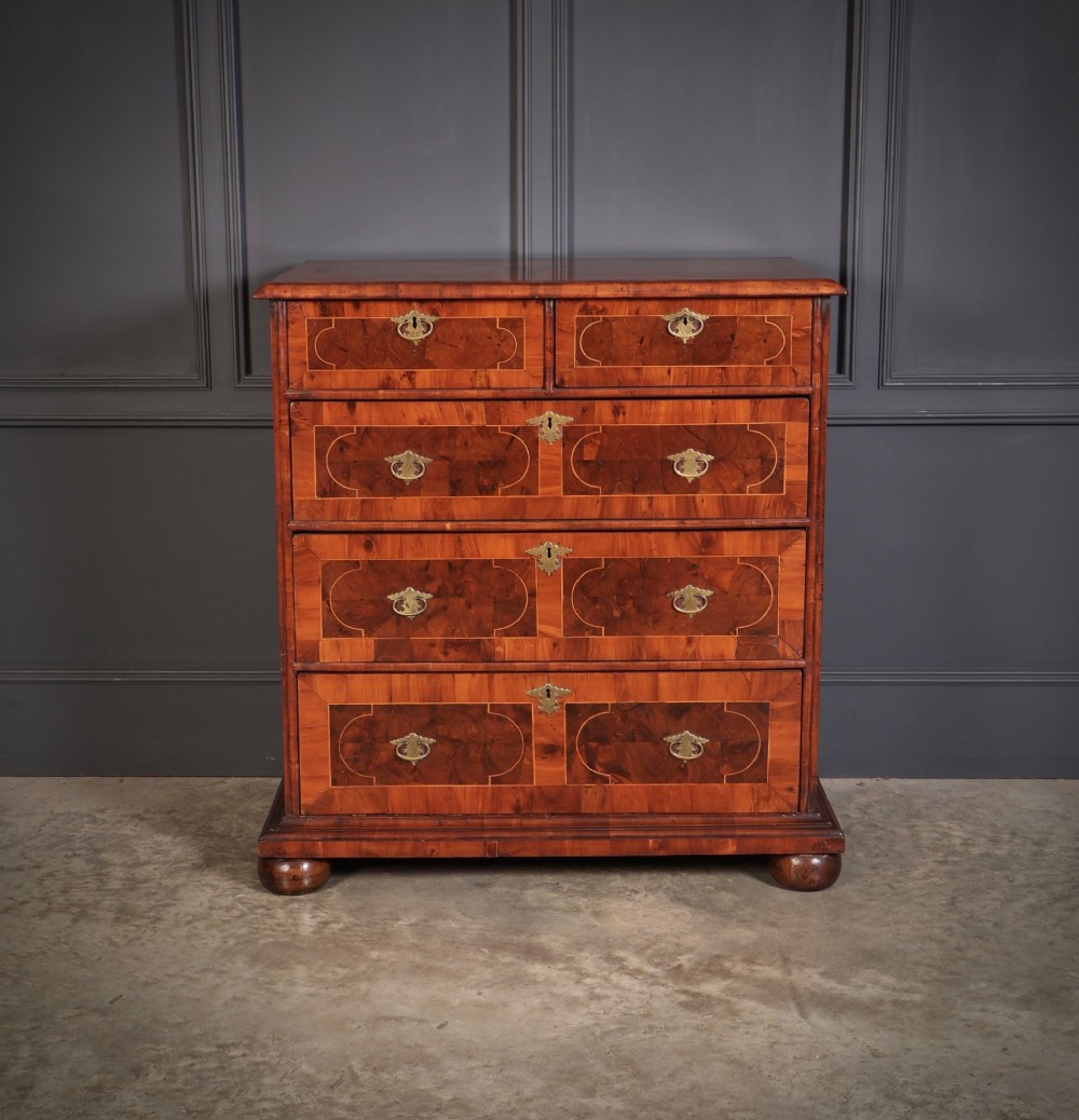 A 17th-century William and Mary chest of drawers featuring geometric oyster veneer, boxwood stringing, brass drop handles, and turned bun feet. View III