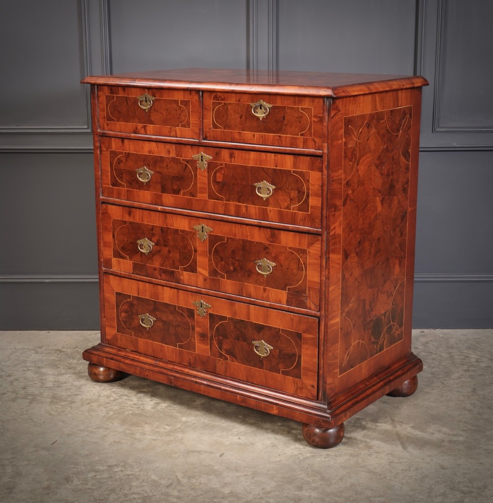 A 17th-century William and Mary chest of drawers featuring geometric oyster veneer, boxwood stringing, brass drop handles, and turned bun feet. View IV