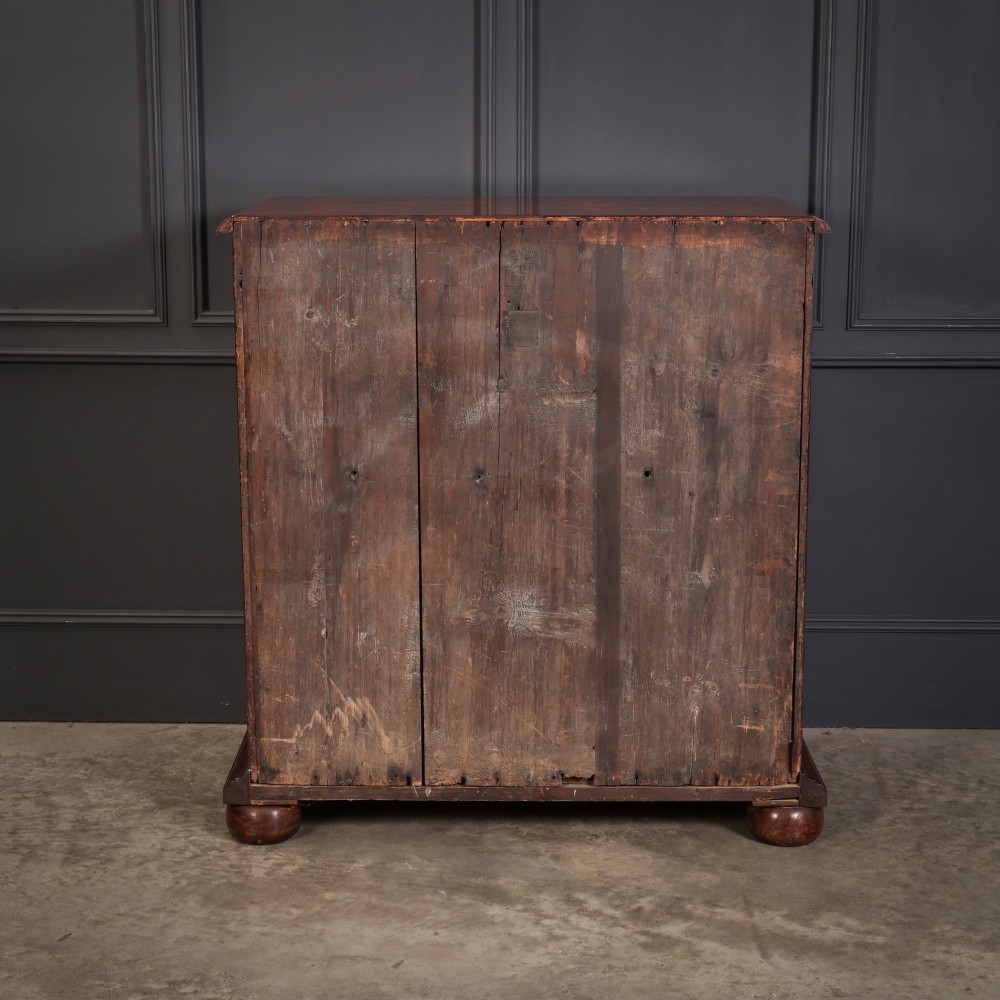 A 17th-century William and Mary chest of drawers featuring geometric oyster veneer, boxwood stringing, brass drop handles, and turned bun feet. View VII