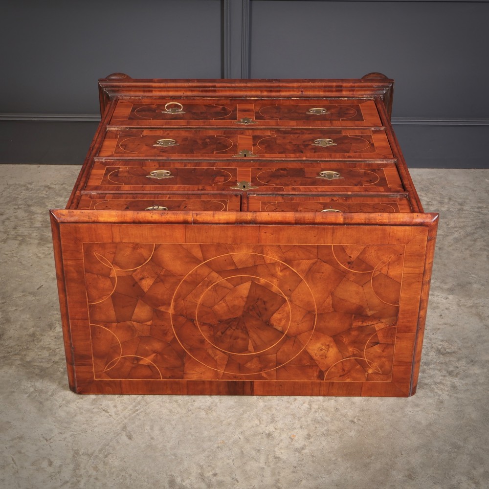A 17th-century William and Mary chest of drawers featuring geometric oyster veneer, boxwood stringing, brass drop handles, and turned bun feet. View VIII