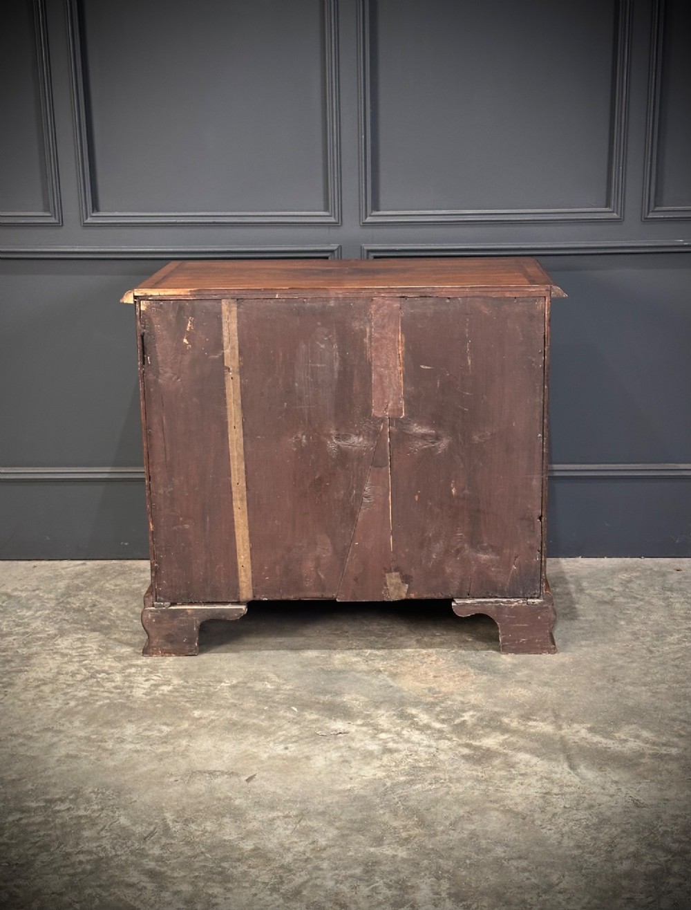 An eighteenth-century Queen Anne walnut chest of drawers featuring two short over two long graduated drawers, brass handles, and shaped bracket feet. View XI