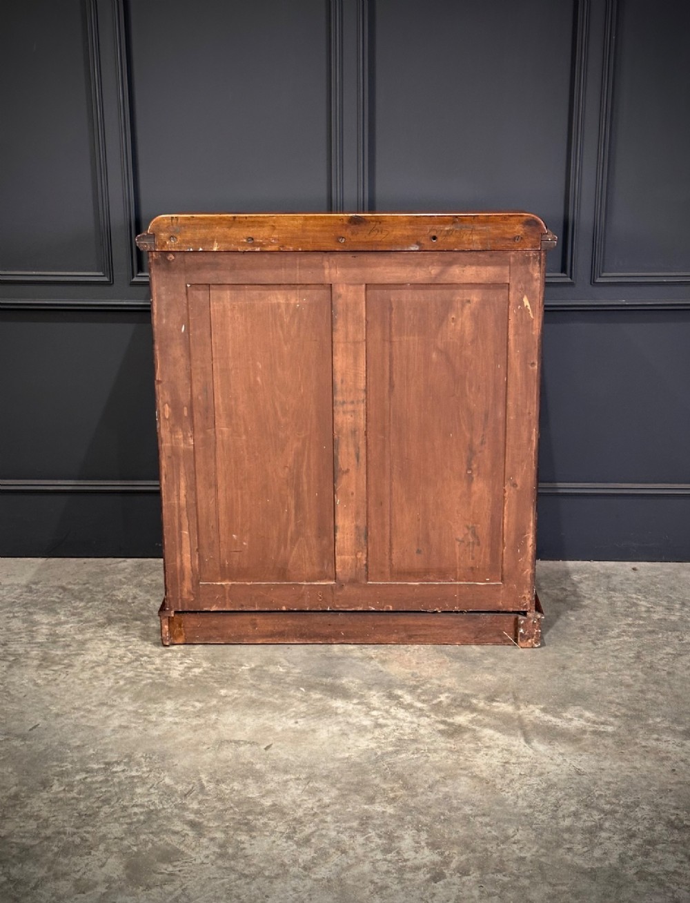 A Victorian flame mahogany chest of drawers featuring two short over three long drawers with turned knobs and a plinth base. View XIV
