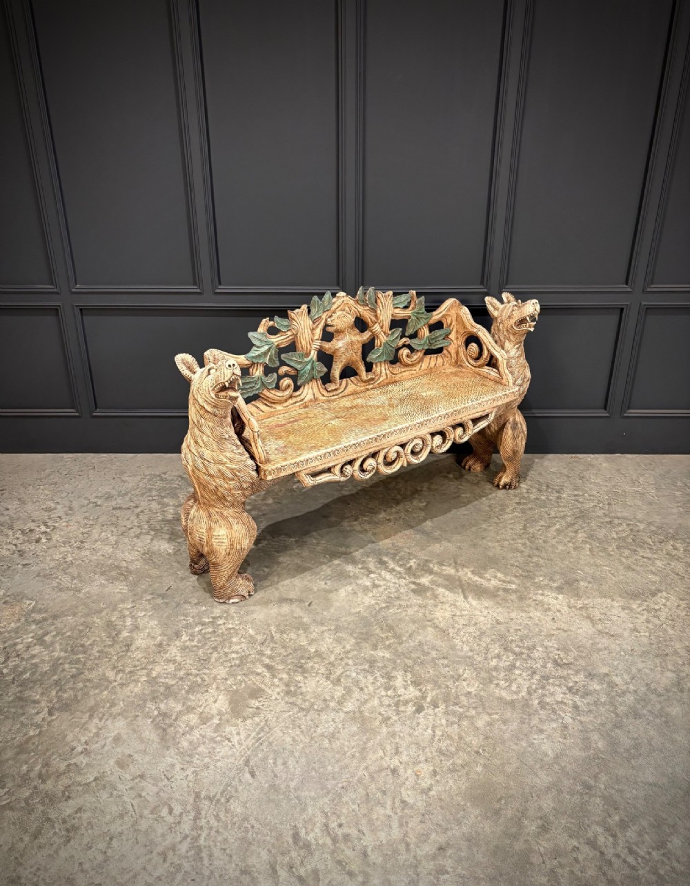 A carved wooden two-seat bench featuring two rearing bears forming the sides and armrests, with scroll motifs and carved green foliage across the backrest. View II