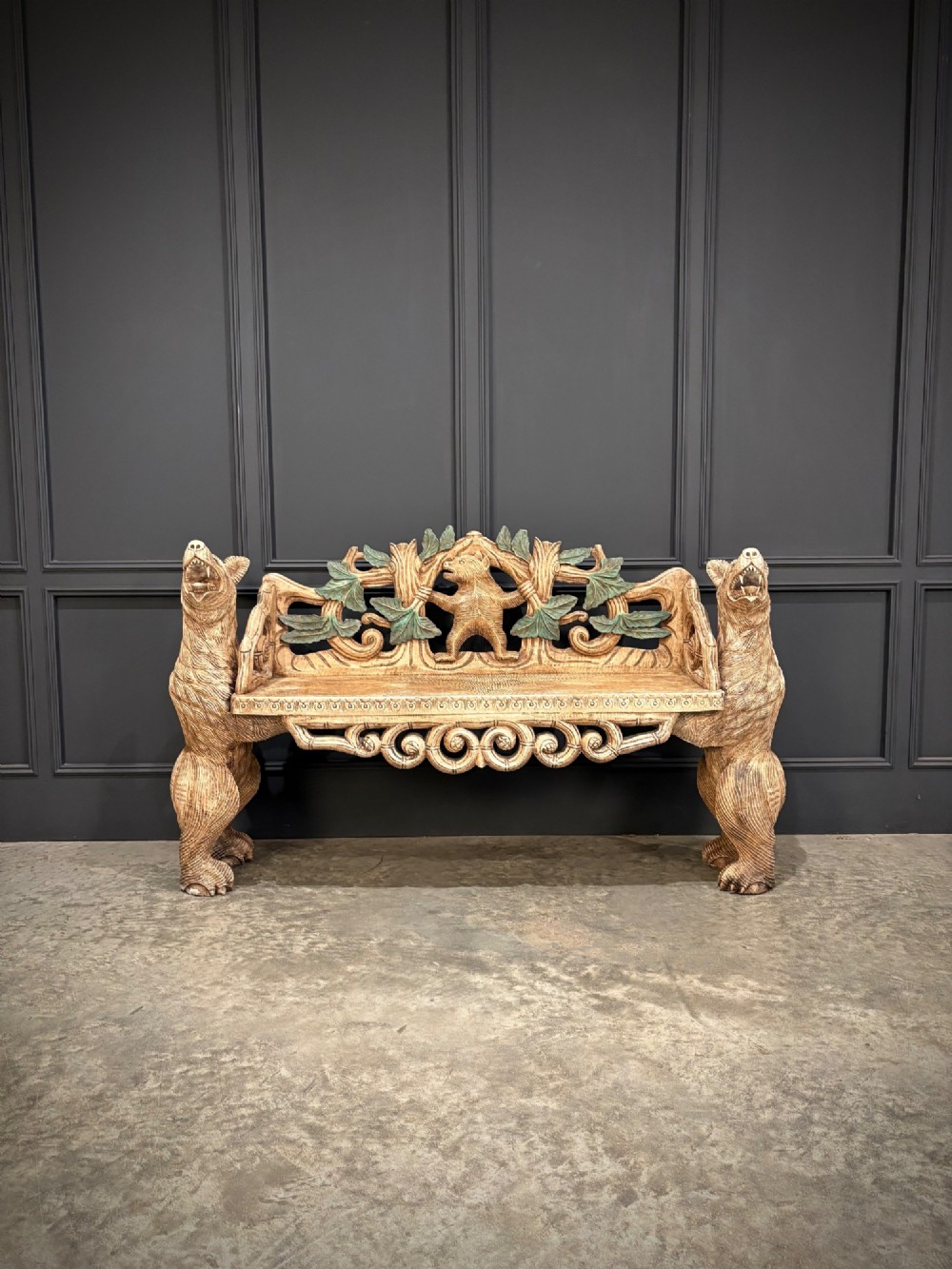 A carved wooden two-seat bench featuring two rearing bears forming the sides and armrests, with scroll motifs and carved green foliage across the backrest. View IV
