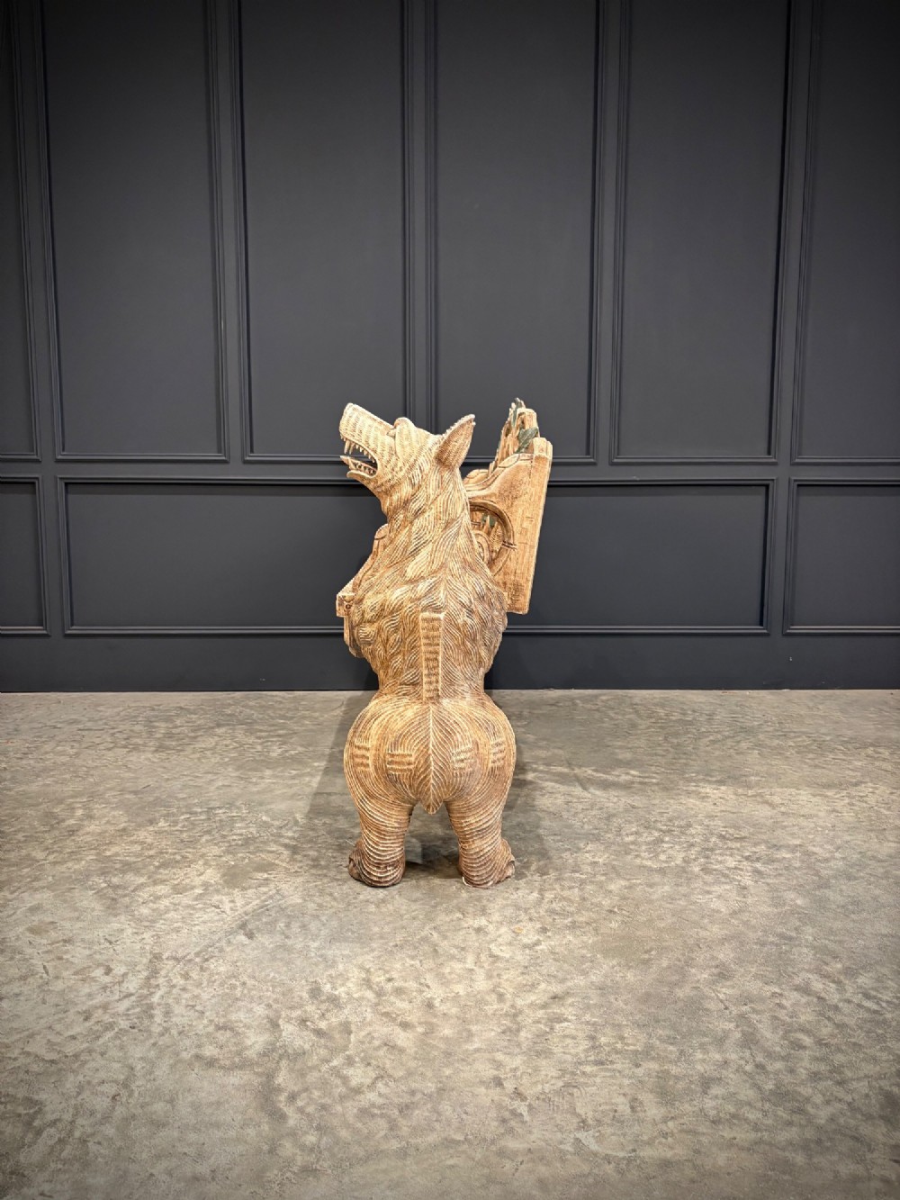 A carved wooden two-seat bench featuring two rearing bears forming the sides and armrests, with scroll motifs and carved green foliage across the backrest. View VIII