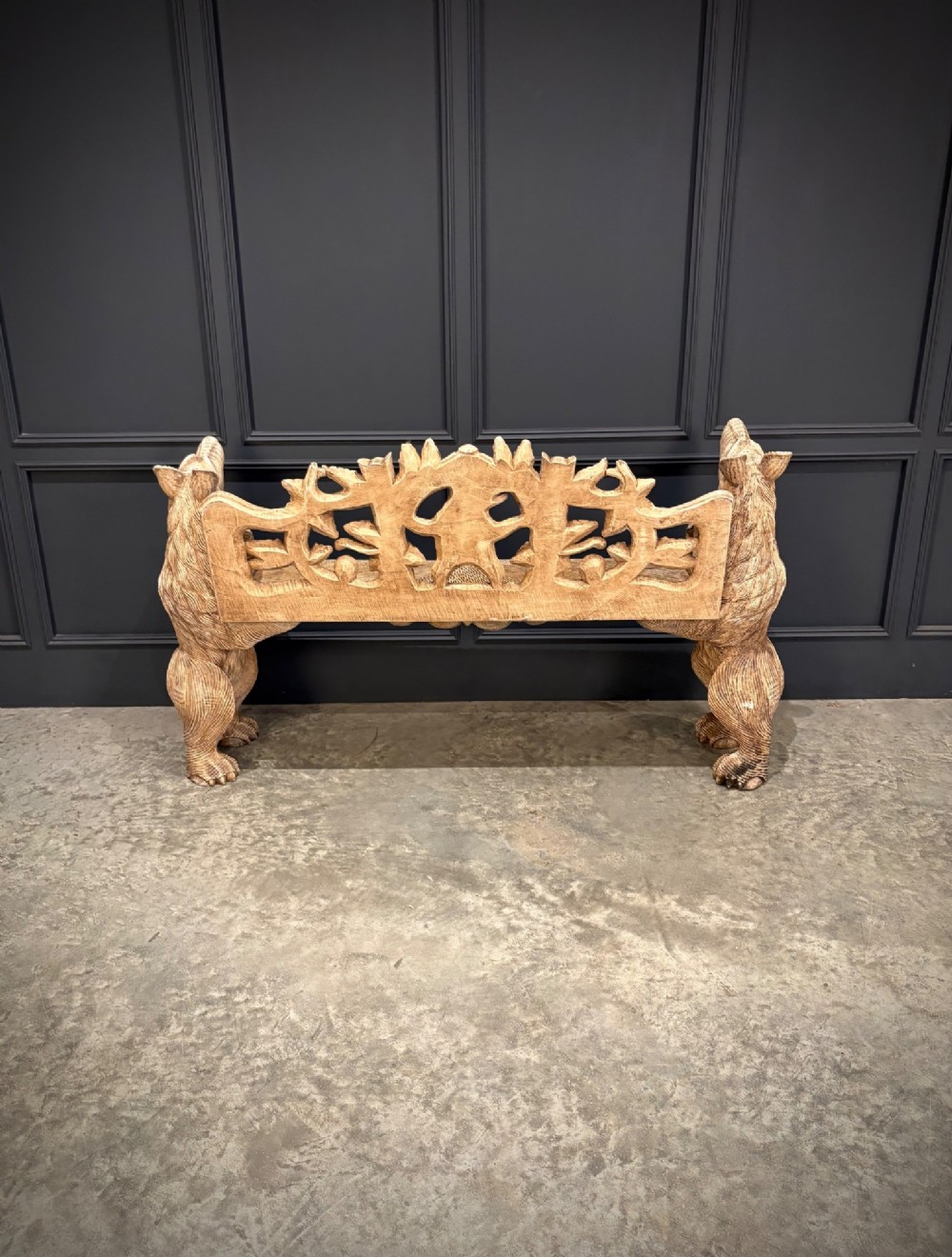 A carved wooden two-seat bench featuring two rearing bears forming the sides and armrests, with scroll motifs and carved green foliage across the backrest. View IX