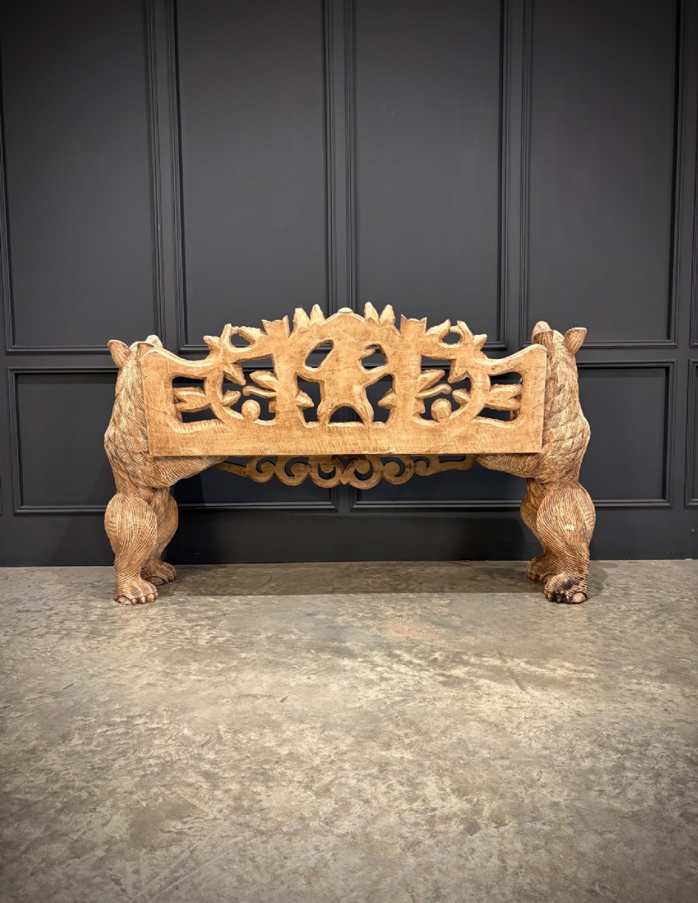 A carved wooden two-seat bench featuring two rearing bears forming the sides and armrests, with scroll motifs and carved green foliage across the backrest. View X