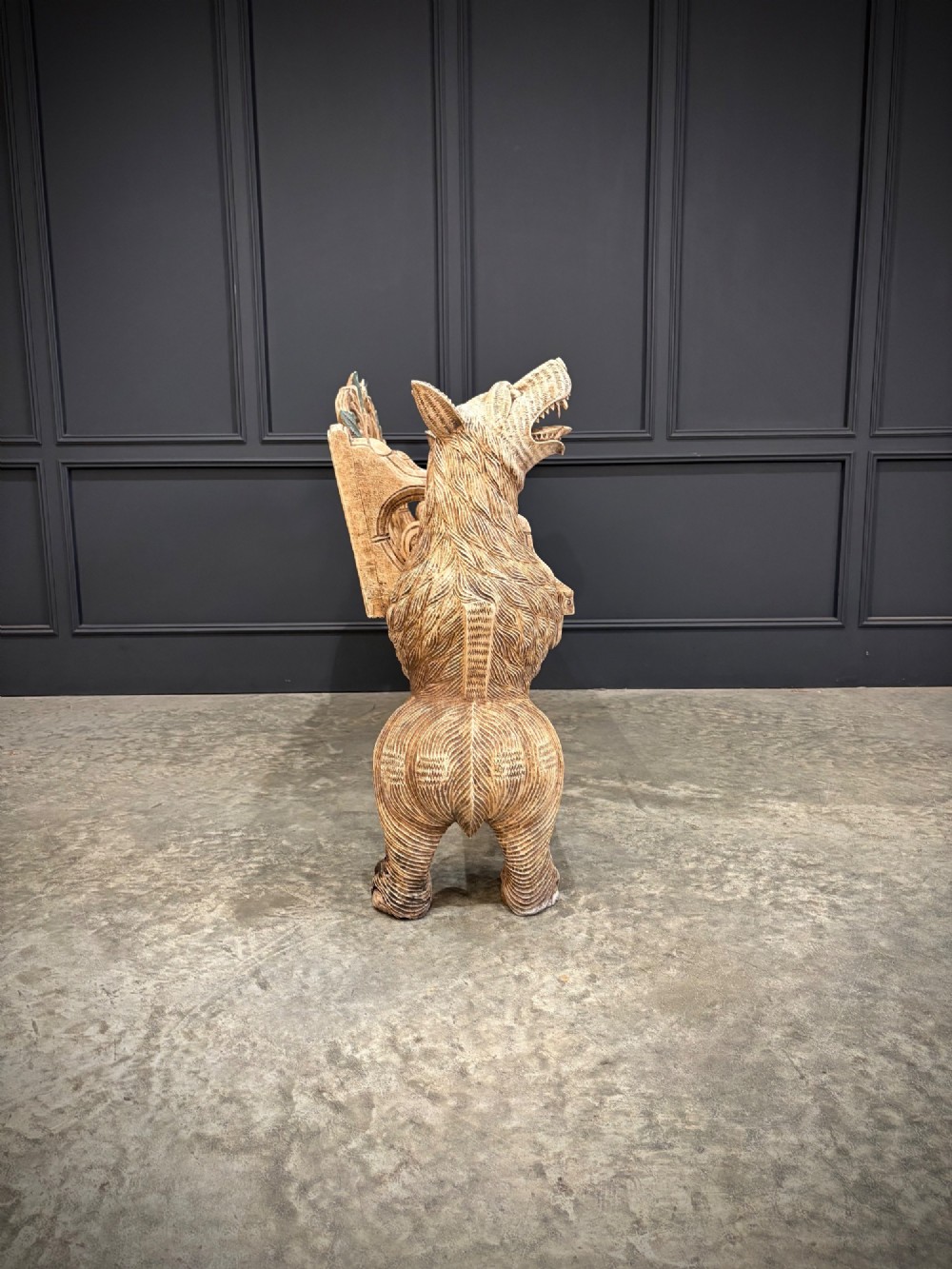 A carved wooden two-seat bench featuring two rearing bears forming the sides and armrests, with scroll motifs and carved green foliage across the backrest. View XI