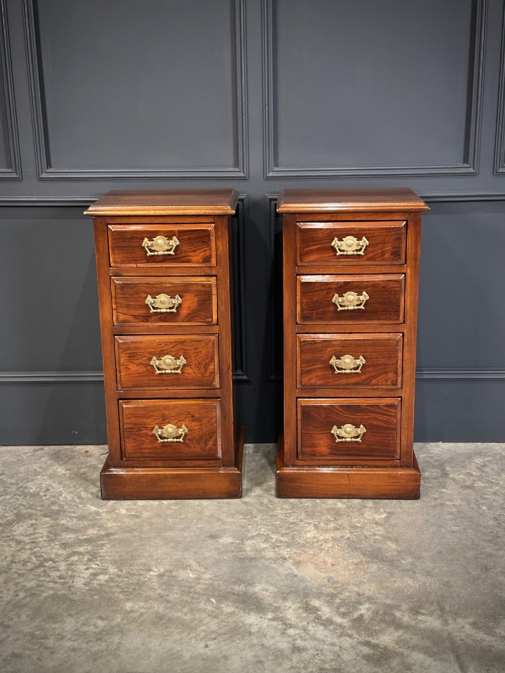 A pair of tall Edwardian mahogany and rosewood four-drawer bedside chests with brass drop handles and plinth bases. View IV