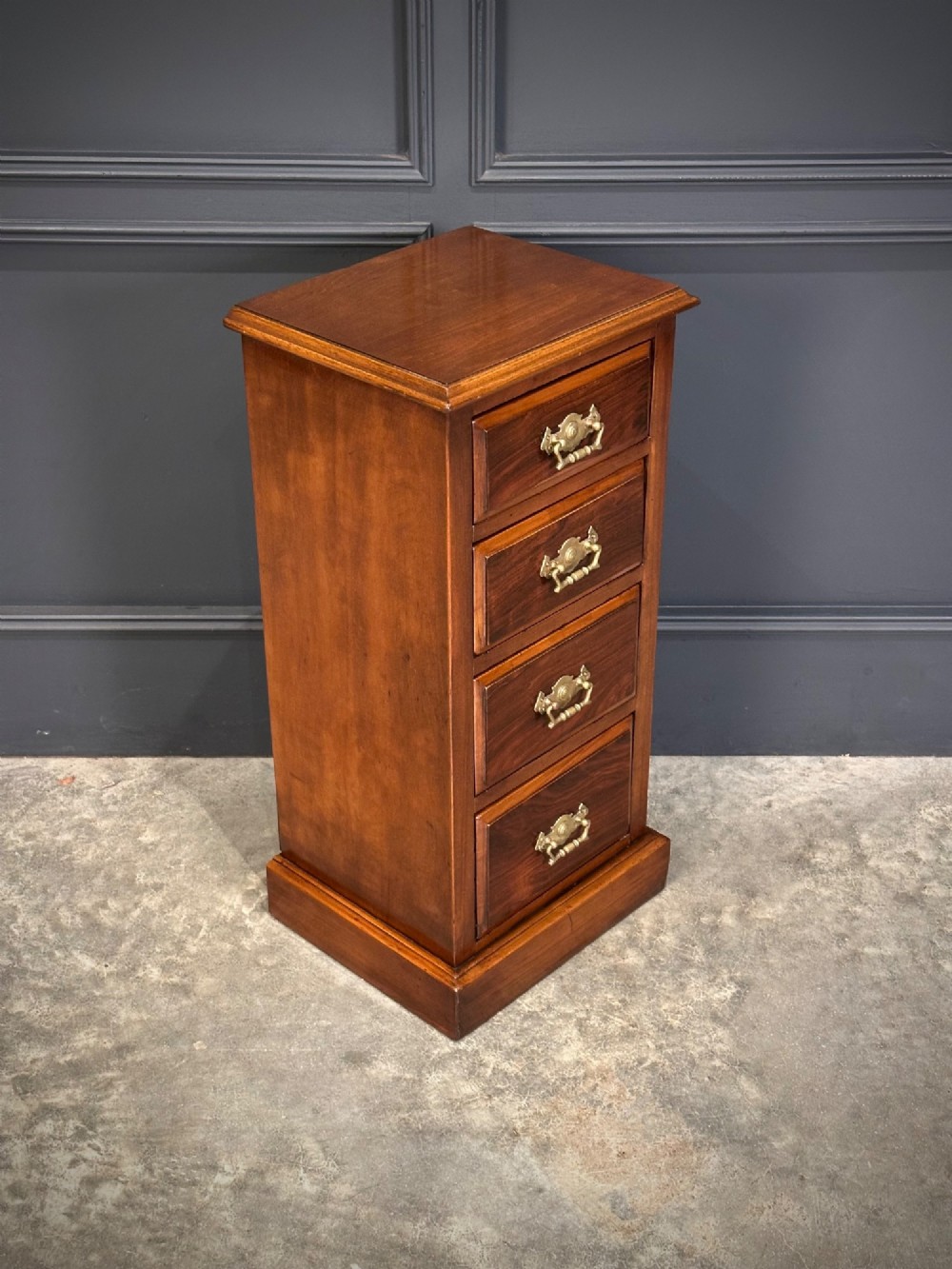 A pair of tall Edwardian mahogany and rosewood four-drawer bedside chests with brass drop handles and plinth bases. View V
