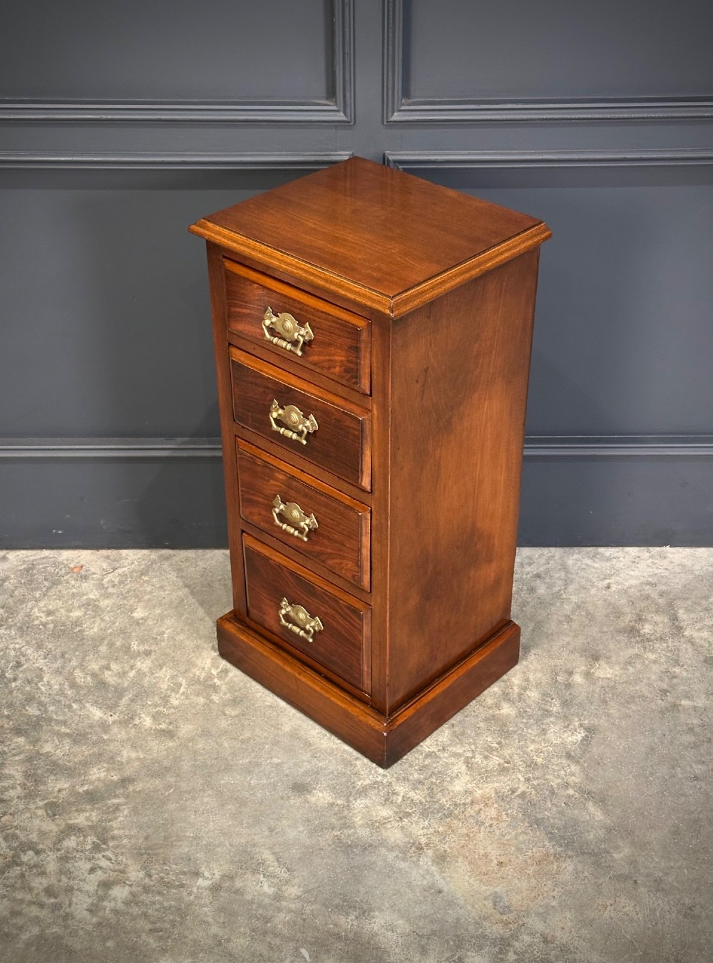 A pair of tall Edwardian mahogany and rosewood four-drawer bedside chests with brass drop handles and plinth bases. View X