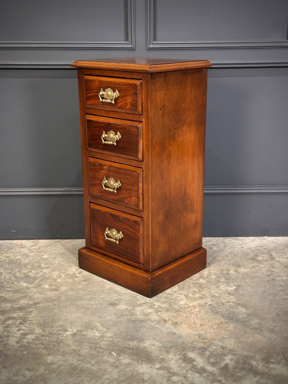 A pair of tall Edwardian mahogany and rosewood four-drawer bedside chests with brass drop handles and plinth bases. View XI