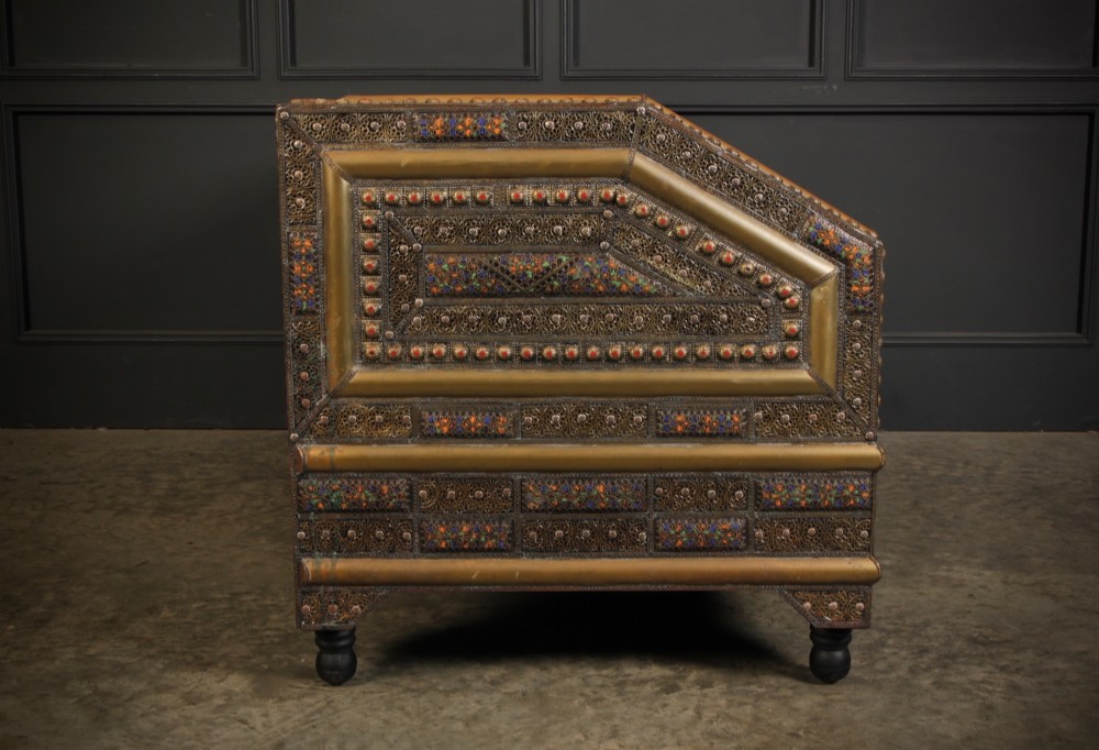 A boxy Moroccan-style sofa featuring tan leather upholstery on the seat and interior, surrounded by an exterior clad in embossed brass metal panels with decorative studding. View XIII
