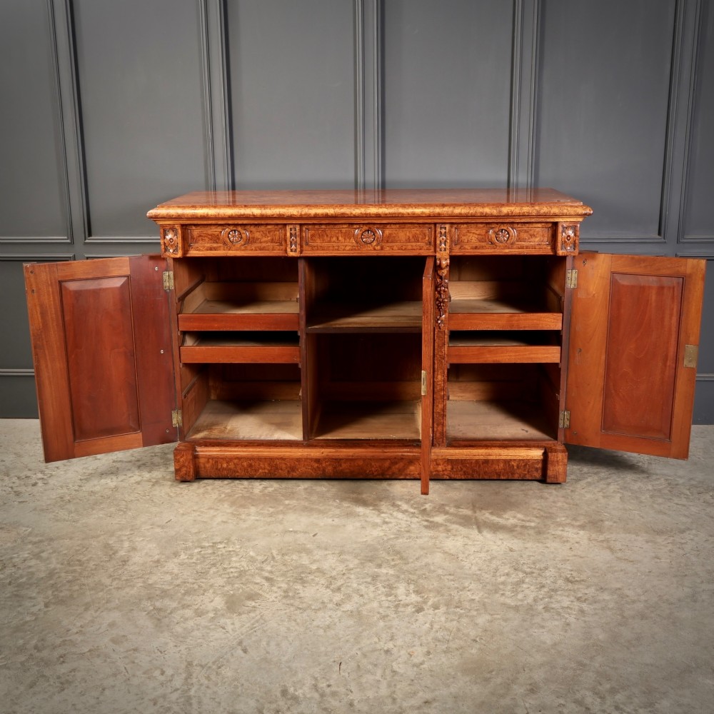 A 19th-century Victorian pollard oak sideboard featuring three relief-panelled cupboard doors, carved corbels, and a figure-rich timber surface. View VI