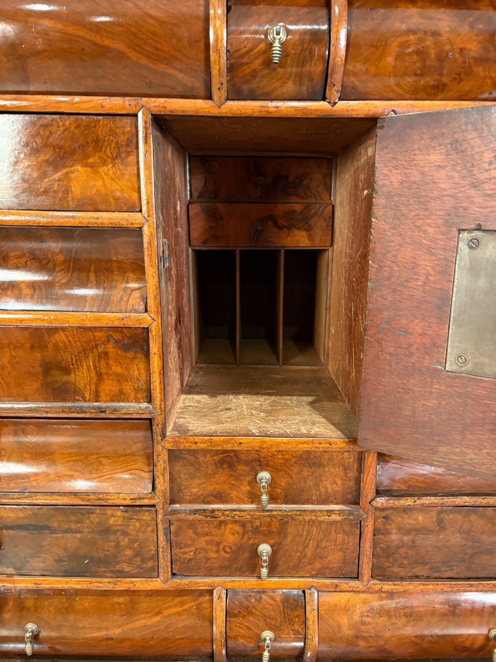 A William and Mary period burr walnut cabinet on stand featuring detailed floral marquetry inlays, teardrop brass handles, and heavy bun feet. View IV