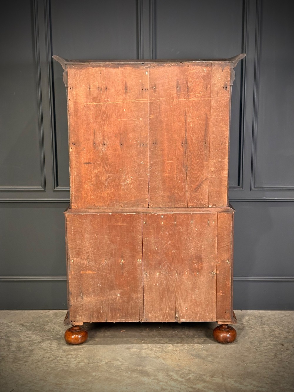 A William and Mary period burr walnut cabinet on stand featuring detailed floral marquetry inlays, teardrop brass handles, and heavy bun feet. View X