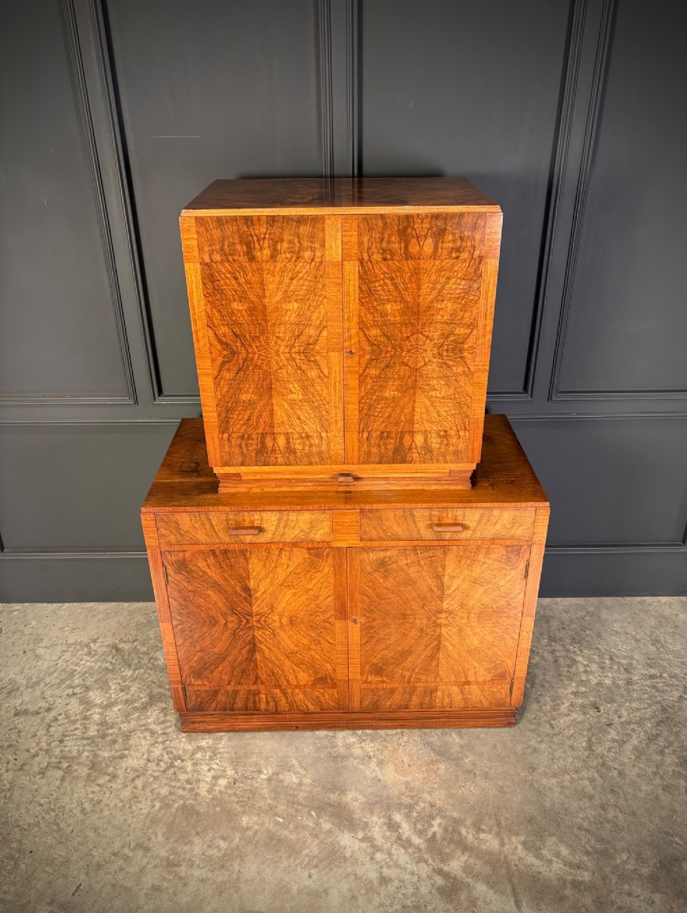 An Art Deco two-tiered cocktail cabinet in figured walnut veneer featuring double doors and geometric paneling. View III