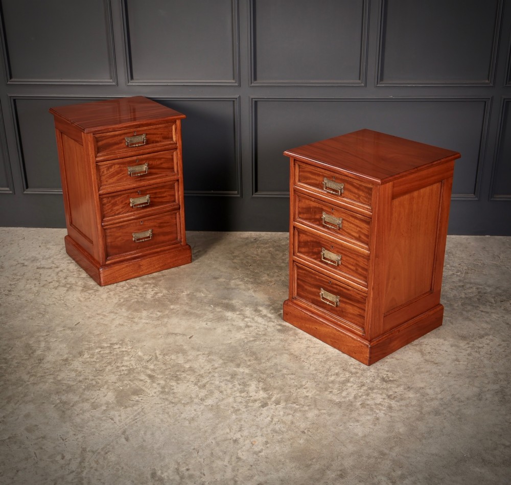 A matching pair of antique Victorian mahogany four-drawer bedside chests featuring plinth bases and brass card-pull handles. View II