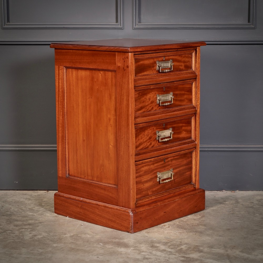 A matching pair of antique Victorian mahogany four-drawer bedside chests featuring plinth bases and brass card-pull handles. View IV