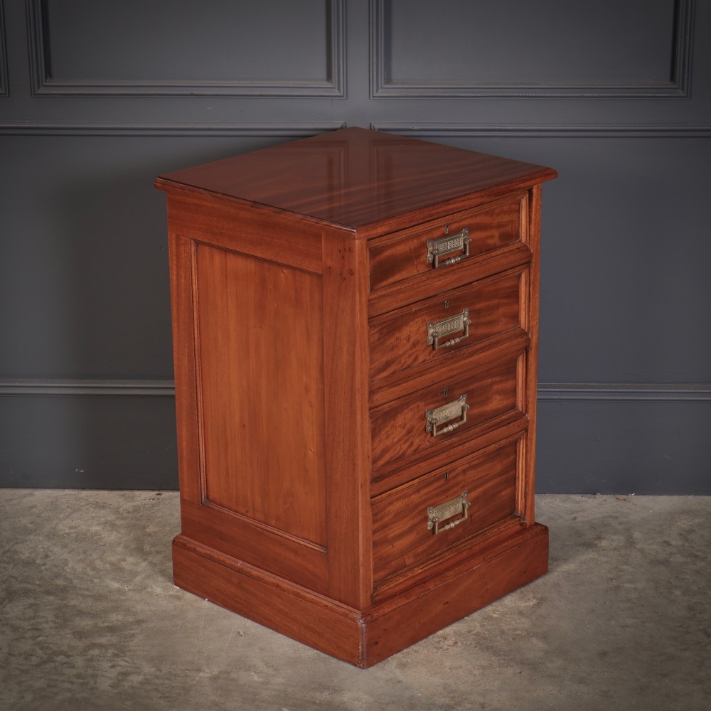A matching pair of antique Victorian mahogany four-drawer bedside chests featuring plinth bases and brass card-pull handles. View V