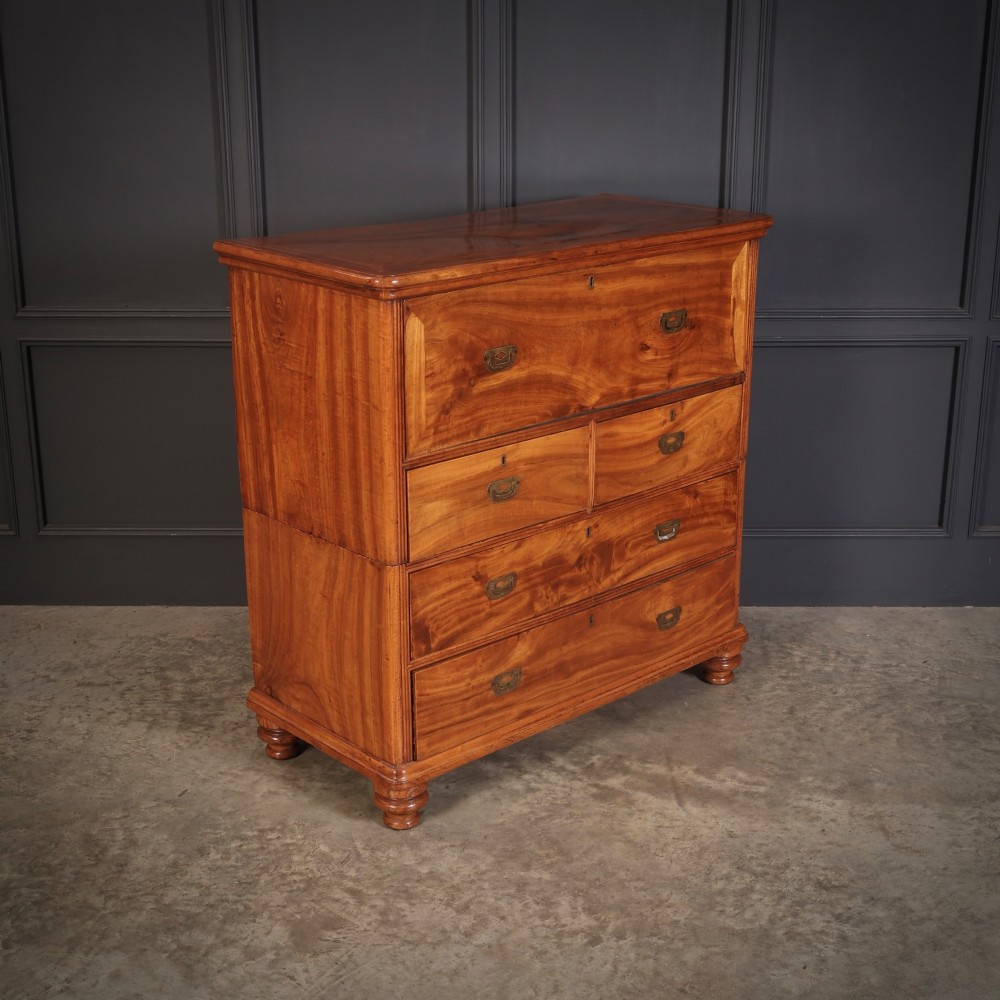 A Victorian two-part camphor wood military campaign chest featuring a secretaire top drawer, flush brass recessed handles, and turned bun feet. View II