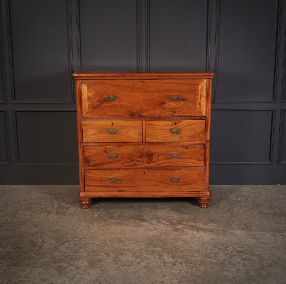 A Victorian two-part camphor wood military campaign chest featuring a secretaire top drawer, flush brass recessed handles, and turned bun feet. View IV
