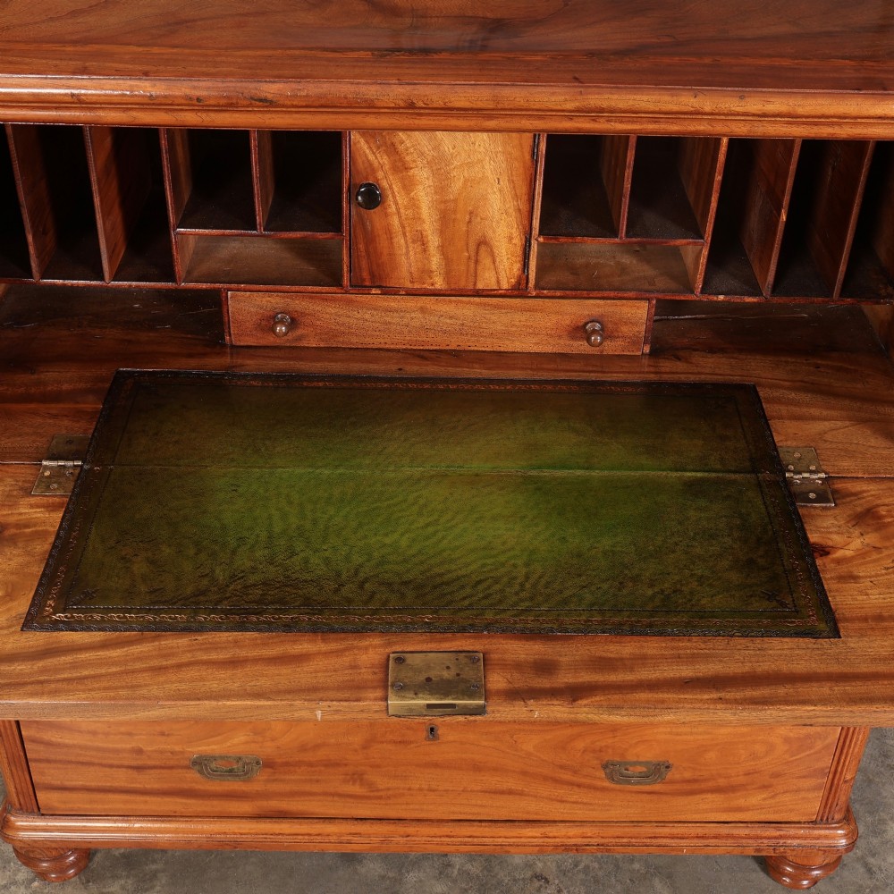 A Victorian two-part camphor wood military campaign chest featuring a secretaire top drawer, flush brass recessed handles, and turned bun feet. View VII