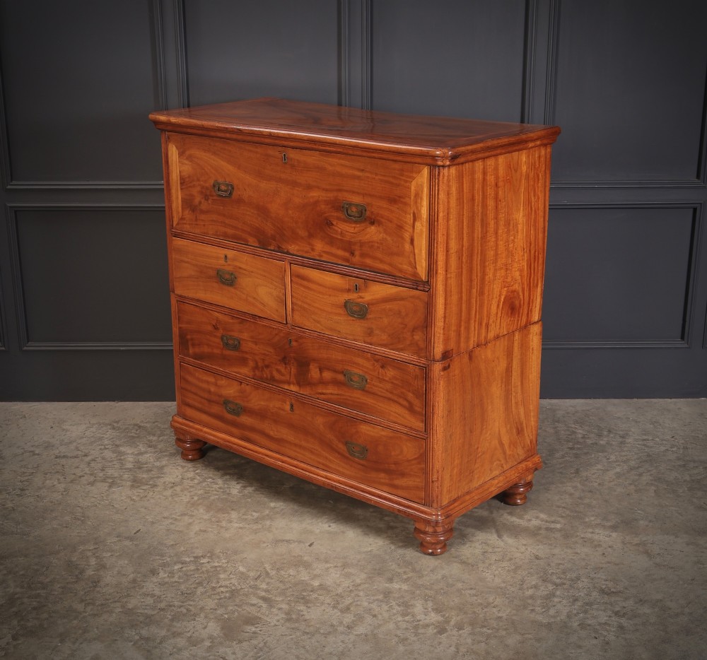 A Victorian two-part camphor wood military campaign chest featuring a secretaire top drawer, flush brass recessed handles, and turned bun feet. View IX