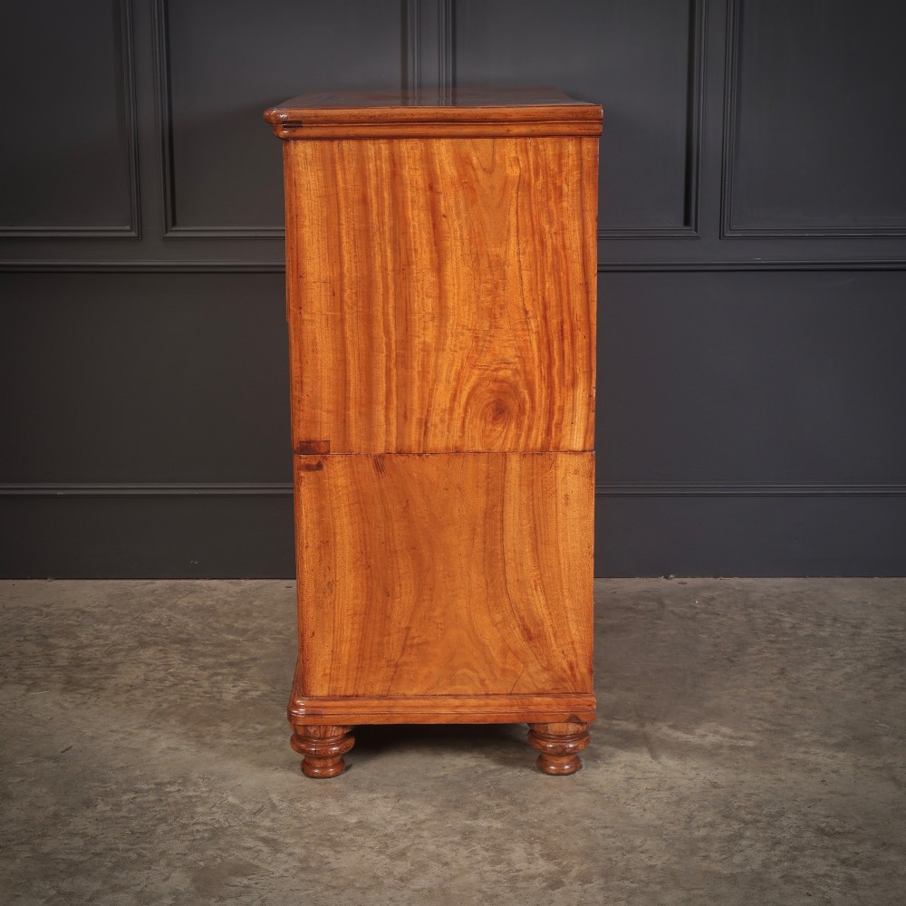 A Victorian two-part camphor wood military campaign chest featuring a secretaire top drawer, flush brass recessed handles, and turned bun feet. View XII