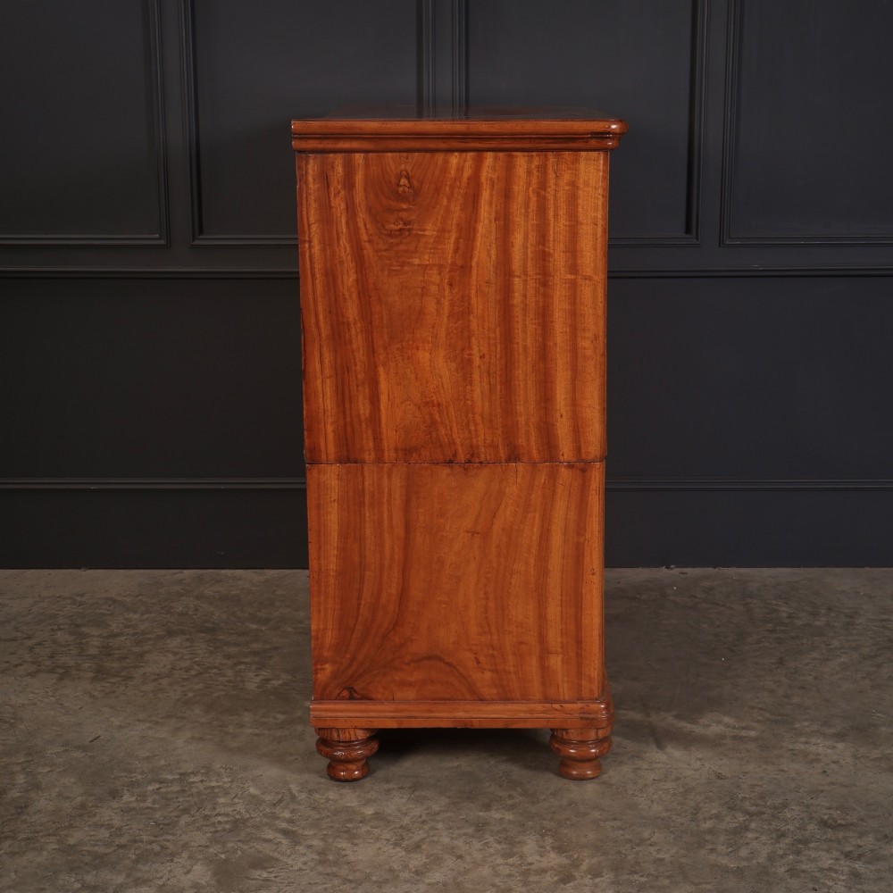 A Victorian two-part camphor wood military campaign chest featuring a secretaire top drawer, flush brass recessed handles, and turned bun feet. View XIV