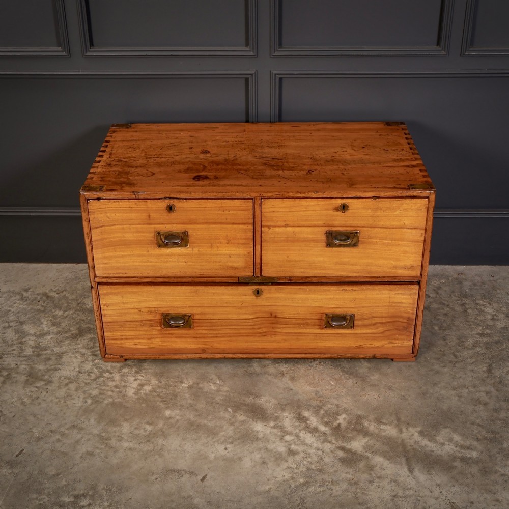 A low rectangular camphor wood campaign chest featuring three drawers with recessed brass handles, brass corner straps, and side carrying handles. View III