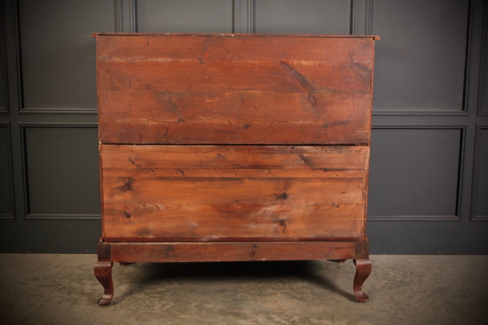An antique walnut chest of drawers featuring a serpentine curved front, four graduated drawers with brass handles, and carved cabriole legs. View XI