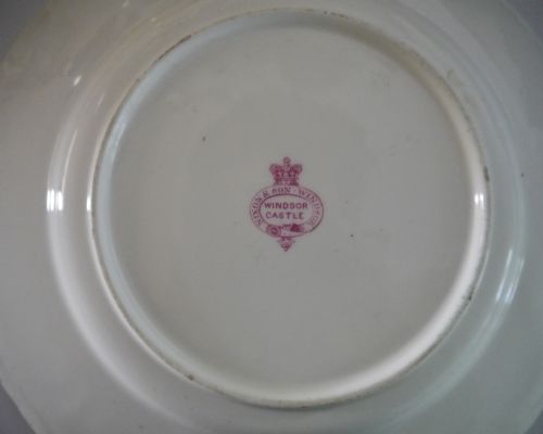 fig 2. A white porcelain dinner plate featuring a cobalt blue scrollwork rim and a central Order of the Garter star insignia.