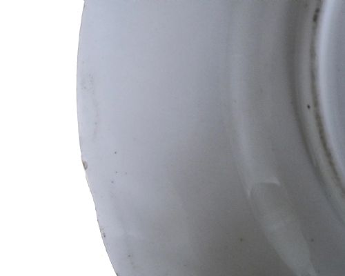fig 1. A white porcelain dinner plate featuring a cobalt blue scrollwork rim and a central Order of the Garter star insignia.