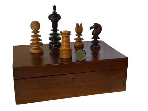 fig 1. A 19th-century English chess set with turned rosewood and boxwood pieces contained within an open hinged wooden presentation box lined with pale green cloth.