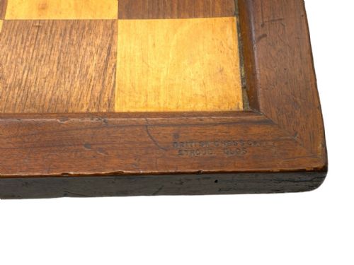 fig 1. A square antique wooden chess board with alternating light and dark wood playing squares surrounded by a dark timber border frame.