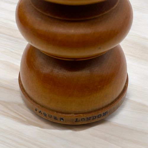 fig 1. A 19th-century St George pattern turned boxwood and ebonised chess set displayed alongside a wooden storage box.