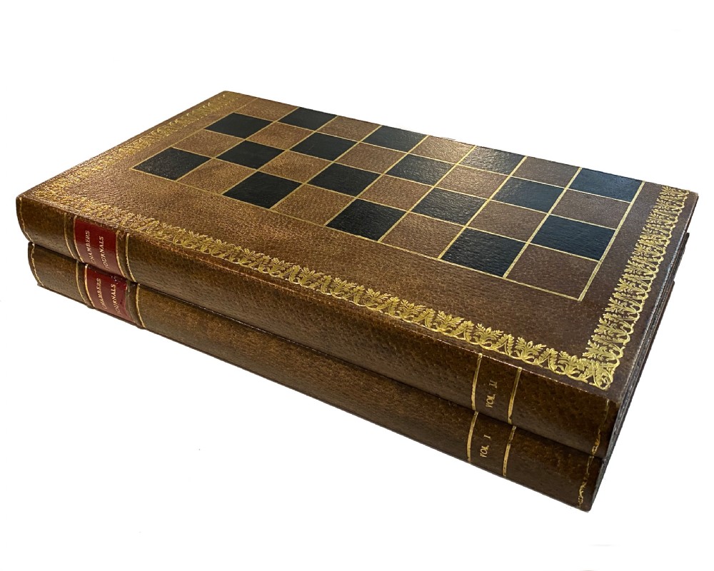 A brown leather folding chess board fashioned to resemble a vintage book with gold gilt tooling along the perimeter. View III