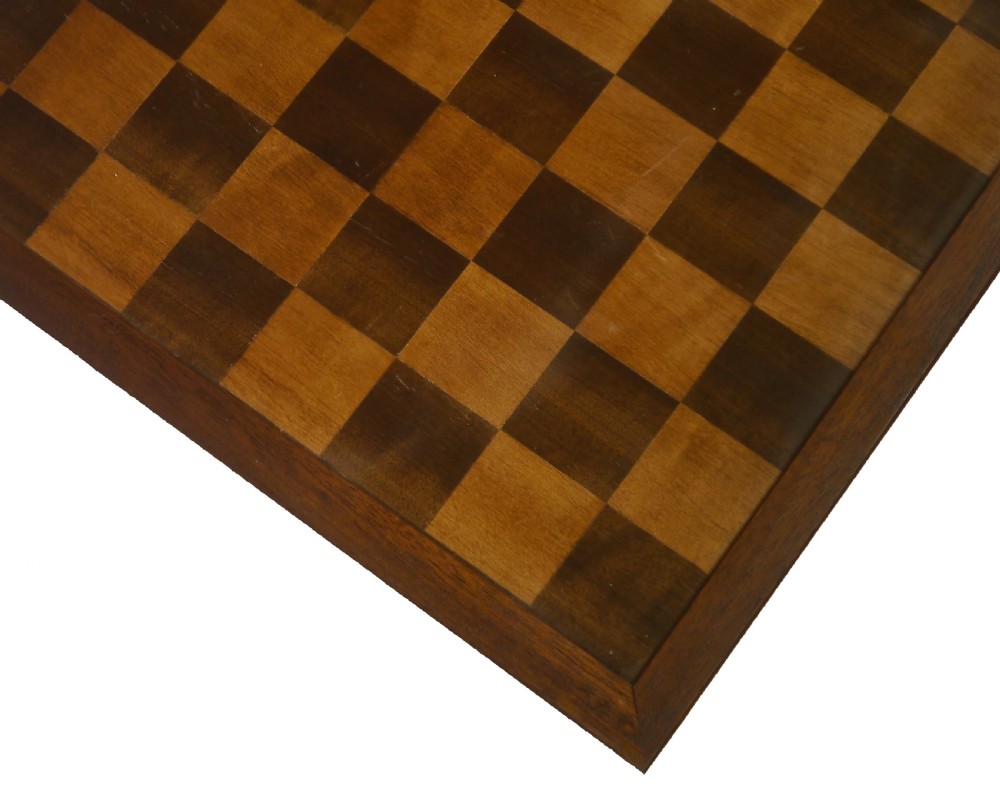 A square antique wooden chess board with alternating light sycamore and dark mahogany inlaid squares within a wooden frame. View III