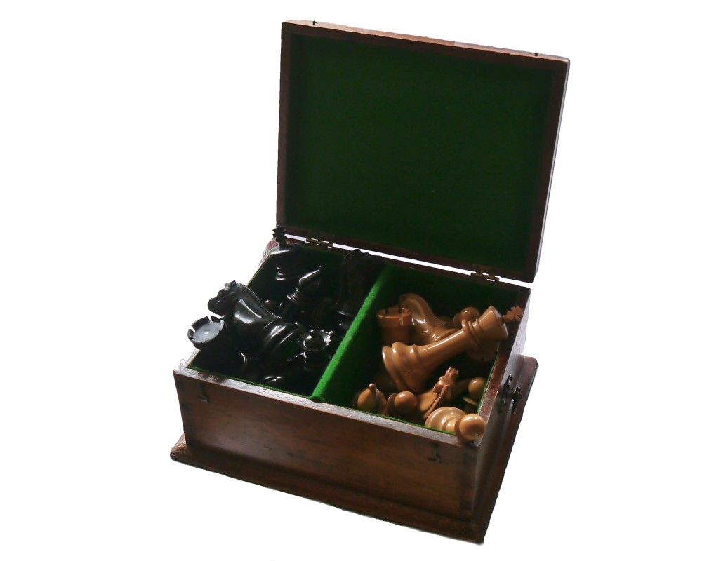 A late 19th-century Staunton chess set featuring carved boxwood and ebony pieces displayed with a fitted wooden storage box. View IV