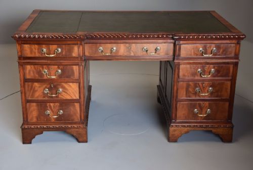 fig 1. Early 20th century mahogany pedestal desk with inverted breakfront green leather top