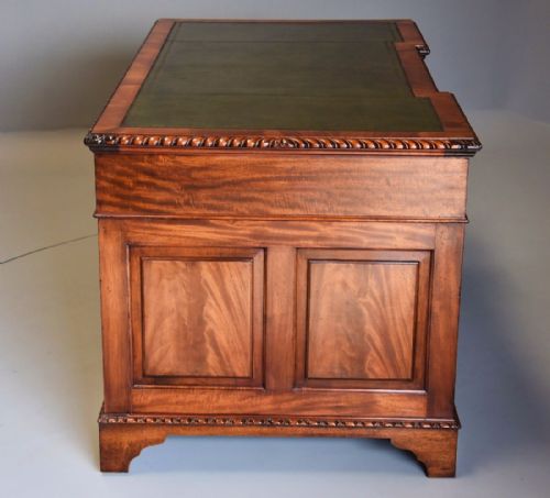 fig 4. Early 20th century mahogany pedestal desk with inverted breakfront green leather top
