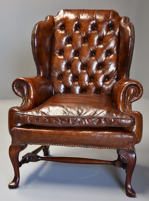 fig 1. Early 20th century Georgian style deep buttoned brown leather wing armchair