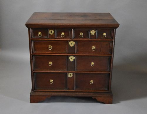 fig 1. Early 18th century oak and elm moulded front chest of drawers of good patina