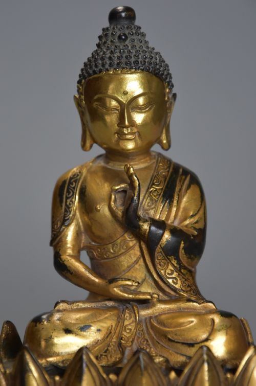 fig 1. Superb quality gilt bronze Tibetan Buddha seated within a lotus flower base