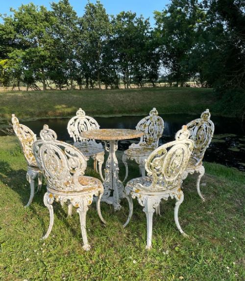 Charming set of six late 19thc cast iron garden chairs and rare late 19thc cast iron  Coalbrookdale garden table