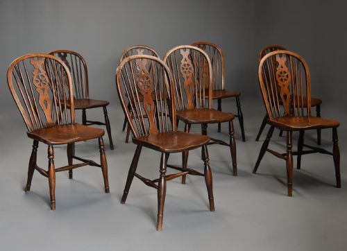 fig 1. Harlequin set of eight mid 19th century ash and elm wheelback Windsor chairs of superb patina