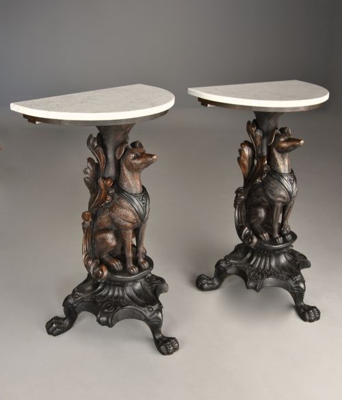 fig 1. Pair of late 19th-century Black Forest demilune side tables featuring carved seated hound pedestals and white marble tops.