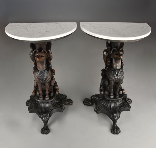 fig 2. Pair of late 19th-century Black Forest demilune side tables featuring carved seated hound pedestals and white marble tops.