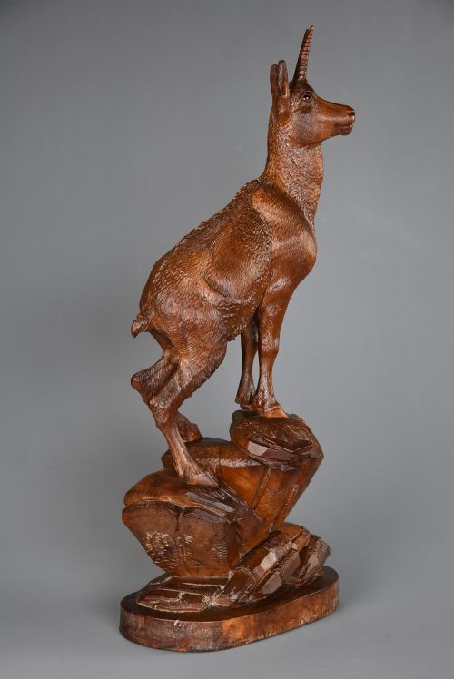 fig 2. A late nineteenth-century hand-carved linden wood sculpture of a female ibex standing on a rocky naturalistic base.